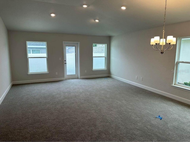unfurnished room with baseboards, a chandelier, carpet, and recessed lighting