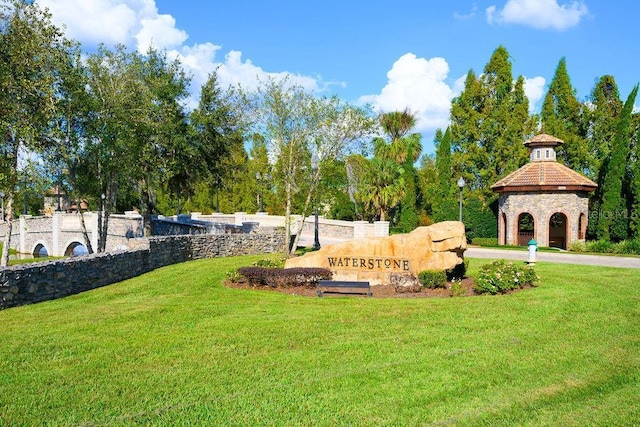 11706 Waterstone Loop Dr, Windermere, FL 34786 - community sign featuring a yard and view of wooded area