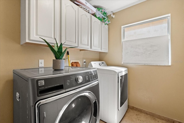 16 Sawfish Ct, Kissimmee, FL 34759 - clothes washing area with washing machine and clothes dryer, cabinet space, and baseboards