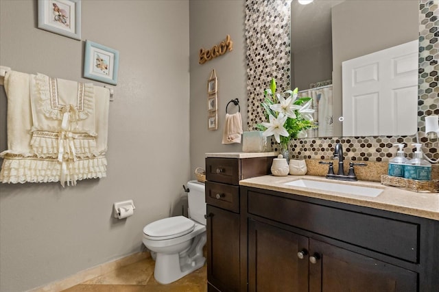 16 Sawfish Ct, Kissimmee, FL 34759 - full bathroom featuring toilet, backsplash, vanity, tile patterned floors, and baseboards