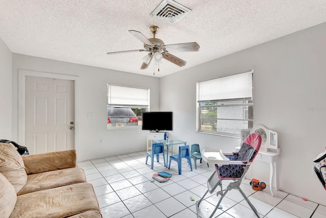 6524/6526 12th St W, Bradenton, FL 34207 - living area featuring ceiling fan, light tile patterned floors, and a textured ceiling