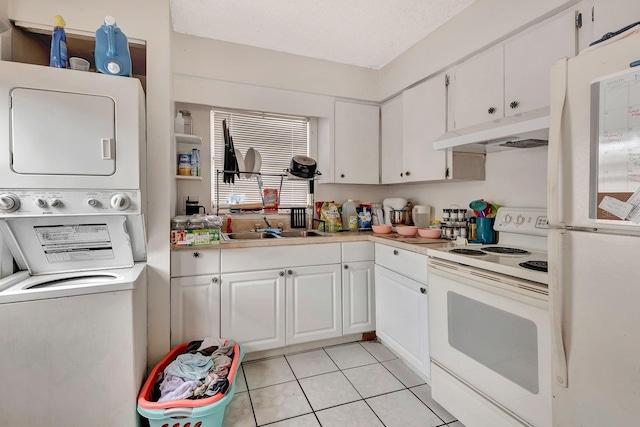 6524/6526 12th St W, Bradenton, FL 34207 - kitchen with white appliances, under cabinet range hood, stacked washer / drying machine, a sink, and light countertops