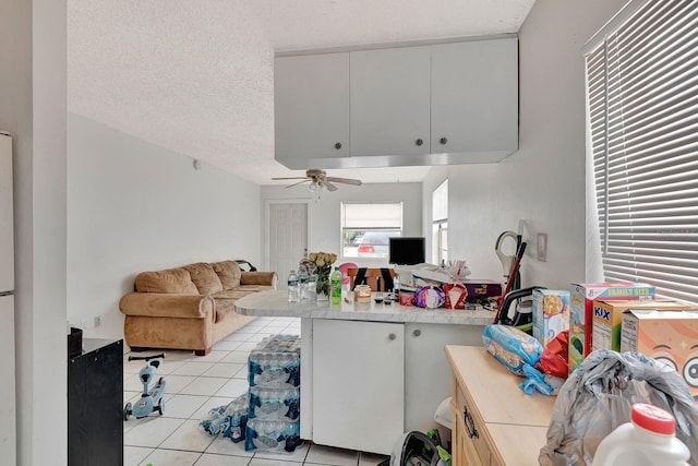 6524/6526 12th St W, Bradenton, FL 34207 - living area with light tile patterned floors, ceiling fan, and a textured ceiling
