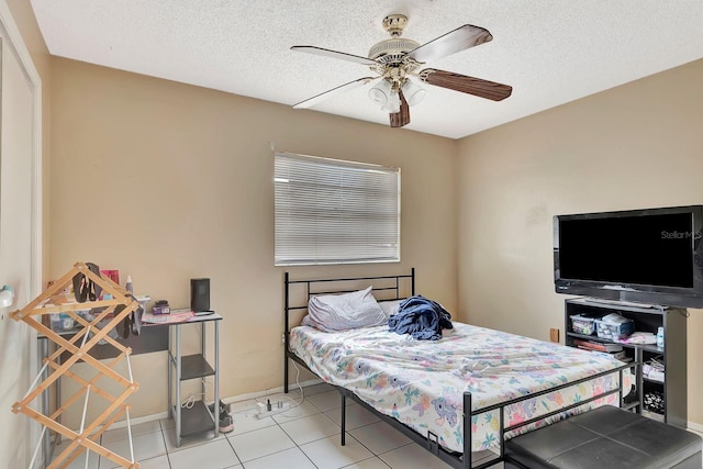 6524/6526 12th St W, Bradenton, FL 34207 - bedroom featuring baseboards, light tile patterned floors, a textured ceiling, and ceiling fan