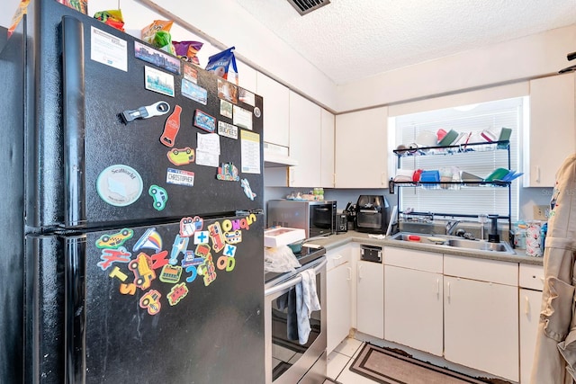 6524/6526 12th St W, Bradenton, FL 34207 - kitchen with stainless steel appliances, under cabinet range hood, a sink, light countertops, and a textured ceiling