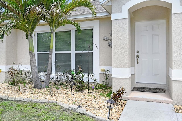 entrance to property with stucco siding