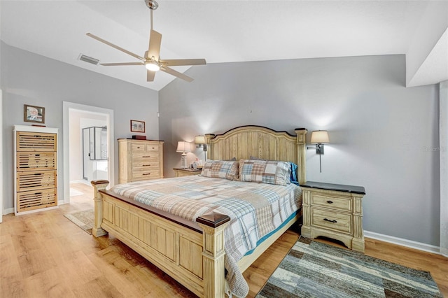 bedroom featuring vaulted ceiling, light wood-style floors, baseboards, and a ceiling fan