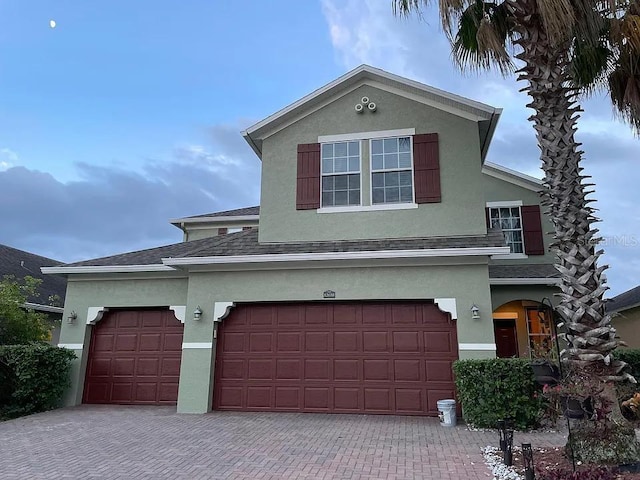 12610 Sawgrass Oak St, Orlando, FL 32824 - traditional-style house with decorative driveway, stucco siding, and a shingled roof
