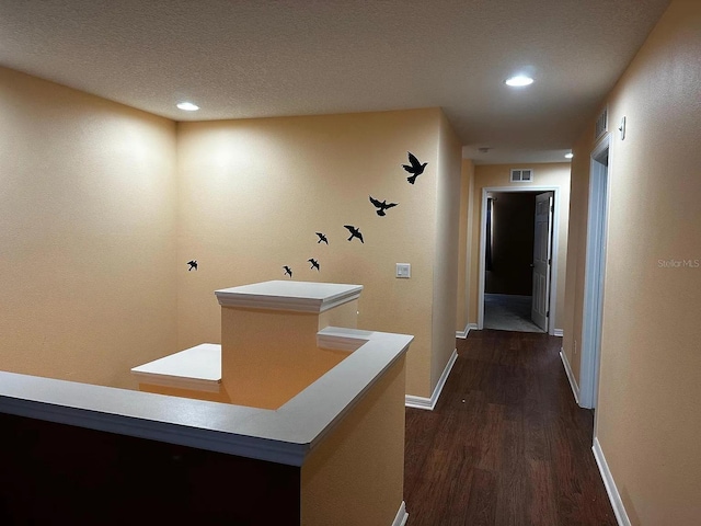12610 Sawgrass Oak St, Orlando, FL 32824 - hallway with dark wood-type flooring, baseboards, recessed lighting, and a textured ceiling