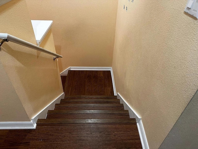 12610 Sawgrass Oak St, Orlando, FL 32824 - stairs featuring a textured wall, wood finished floors, and baseboards