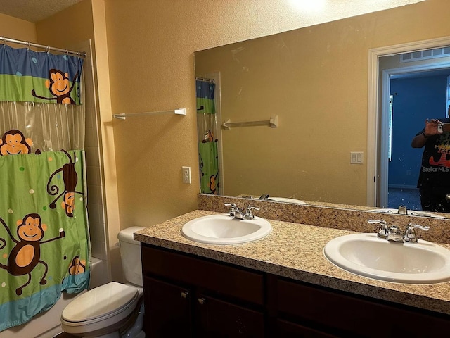 12610 Sawgrass Oak St, Orlando, FL 32824 - full bathroom with a textured wall, shower / bath combo with shower curtain, double vanity, and toilet