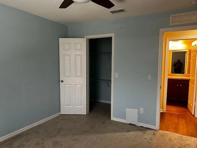 12610 Sawgrass Oak St, Orlando, FL 32824 - unfurnished bedroom featuring a walk in closet, carpet floors, a closet, baseboards, and ceiling fan