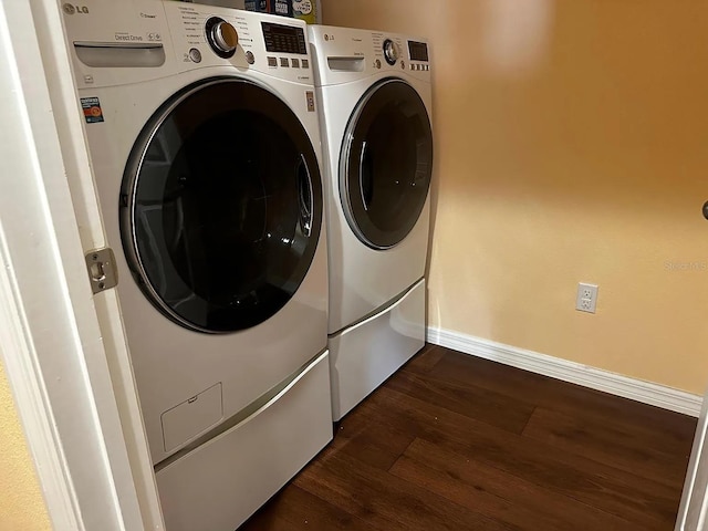 12610 Sawgrass Oak St, Orlando, FL 32824 - laundry room with washing machine and clothes dryer, baseboards, and dark wood-style floors