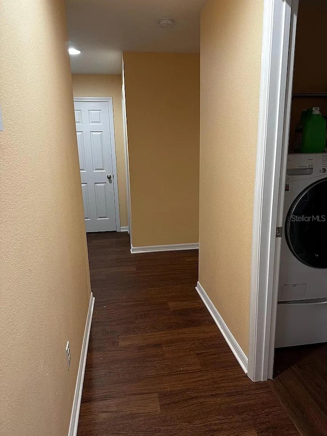12610 Sawgrass Oak St, Orlando, FL 32824 - hall featuring washer / clothes dryer, dark wood-style flooring, baseboards, and a textured wall