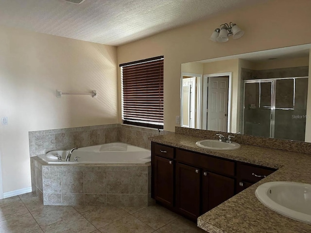 12610 Sawgrass Oak St, Orlando, FL 32824 - full bath featuring a shower stall, a bath, vanity, tile patterned floors, and a textured ceiling