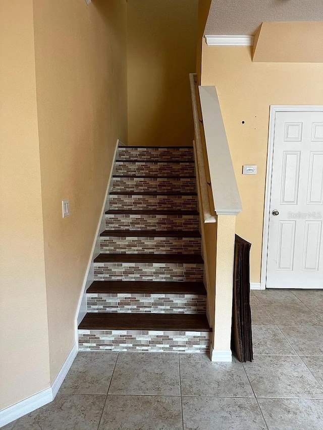 12610 Sawgrass Oak St, Orlando, FL 32824 - stairs with tile patterned floors, baseboards, and crown molding