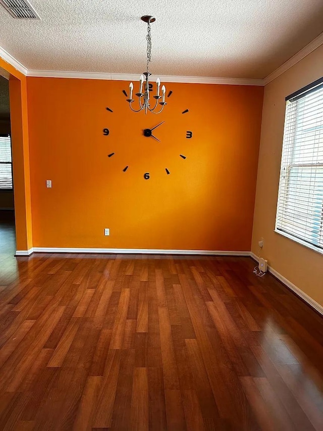12610 Sawgrass Oak St, Orlando, FL 32824 - unfurnished dining area featuring wood finished floors, a chandelier, a textured ceiling, crown molding, and baseboards