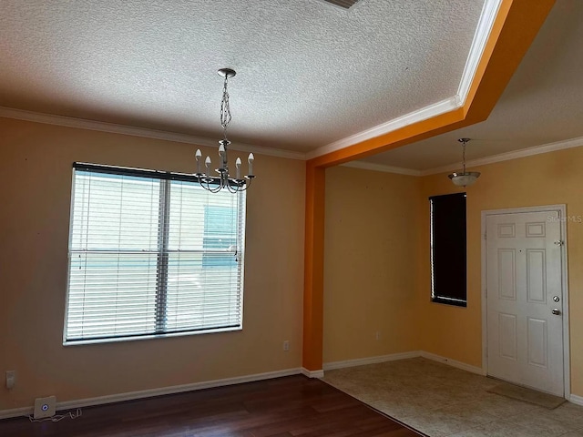 12610 Sawgrass Oak St, Orlando, FL 32824 - spare room featuring a chandelier, crown molding, a textured ceiling, wood finished floors, and baseboards