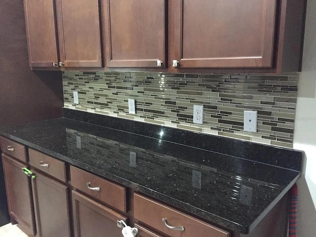 12610 Sawgrass Oak St, Orlando, FL 32824 - kitchen with tasteful backsplash and dark stone counters