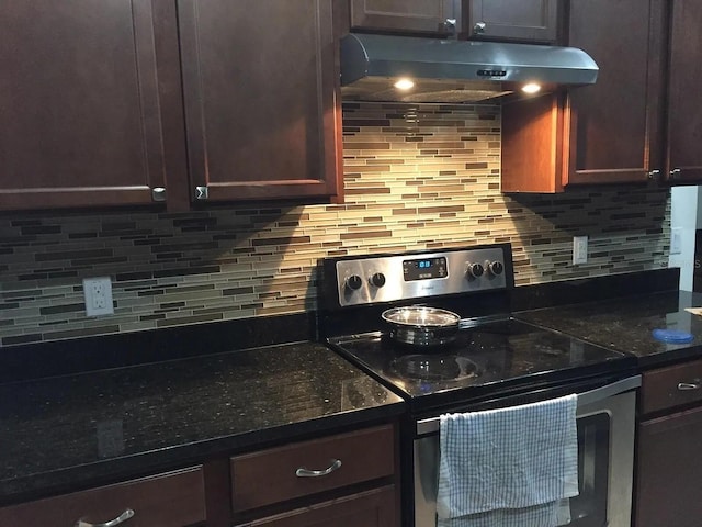 12610 Sawgrass Oak St, Orlando, FL 32824 - kitchen featuring stainless steel range with electric stovetop, under cabinet range hood, decorative backsplash, and dark brown cabinets