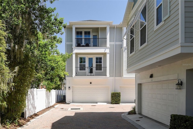 117 E Concord St Unit 7, Orlando, FL 32801 - view of front of home with a garage, a balcony, fence, and driveway