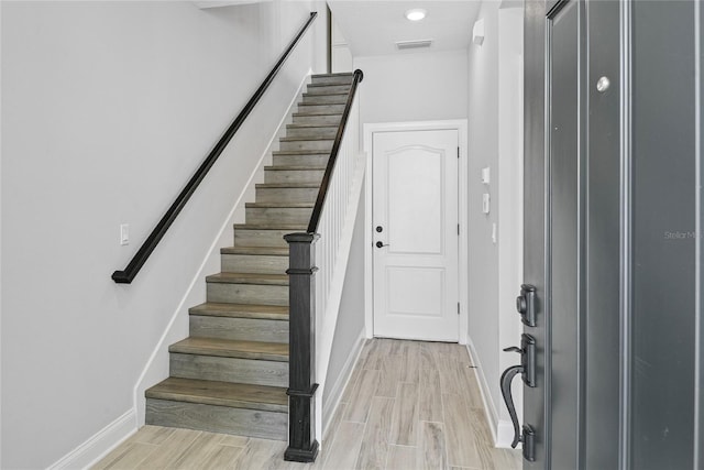 117 E Concord St Unit 7, Orlando, FL 32801 - entryway with baseboards, wood tiled floors, and stairway