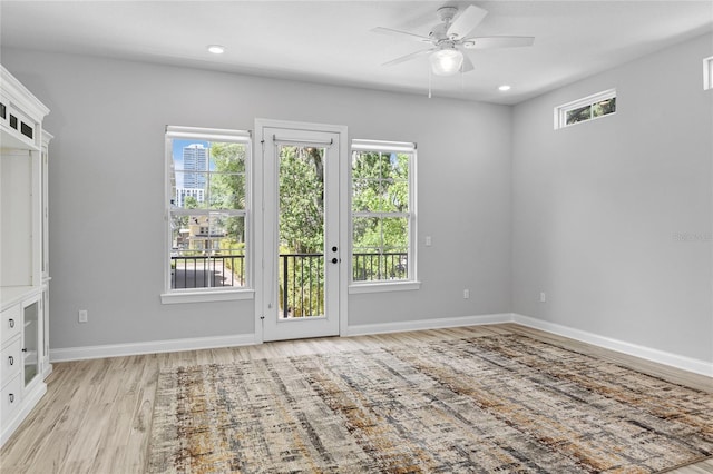 117 E Concord St Unit 7, Orlando, FL 32801 - spare room with healthy amount of natural light, light wood-style floors, ceiling fan, baseboards, and recessed lighting