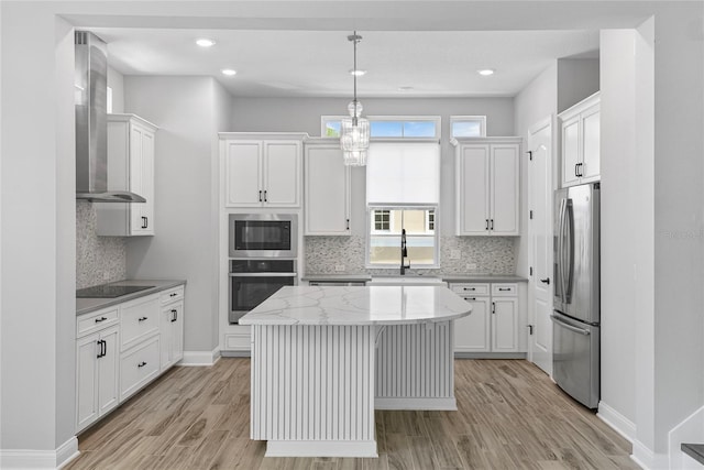 117 E Concord St Unit 7, Orlando, FL 32801 - kitchen featuring appliances with stainless steel finishes, a kitchen island, a sink, light wood-style flooring, and recessed lighting