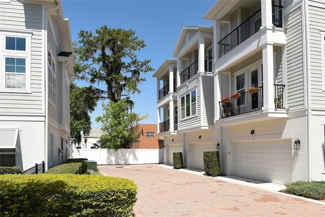 117 E Concord St Unit 7, Orlando, FL 32801 - view of property exterior with an attached garage, fence, and driveway
