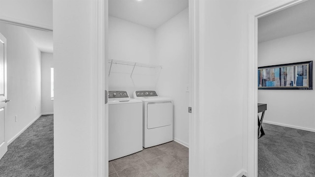 laundry room featuring washing machine and clothes dryer, light carpet, and baseboards