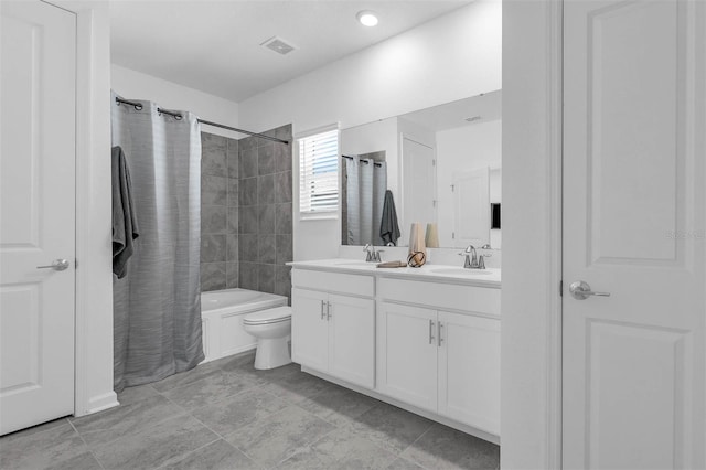 bathroom featuring double vanity, toilet, and shower / tub combo
