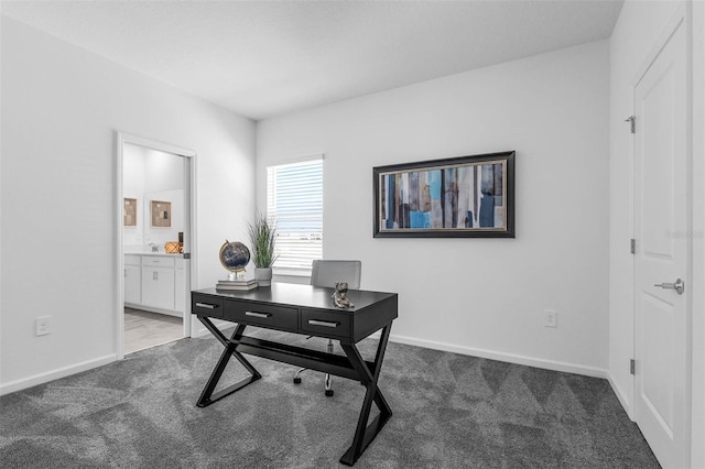 carpeted home office with baseboards