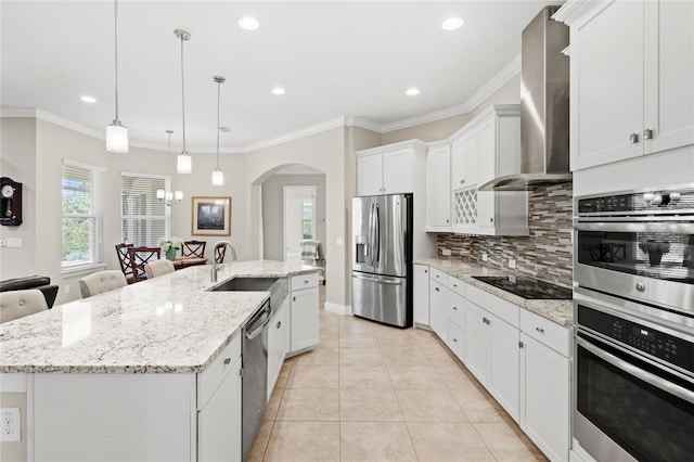 31754 Red Tail Blvd, Sorrento, FL 32776 - kitchen featuring appliances with stainless steel finishes, wall chimney range hood, a sink, decorative backsplash, and a spacious island