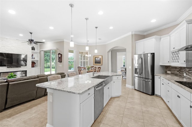 31754 Red Tail Blvd, Sorrento, FL 32776 - kitchen featuring appliances with stainless steel finishes, a center island with sink, arched walkways, ceiling fan, and open floor plan