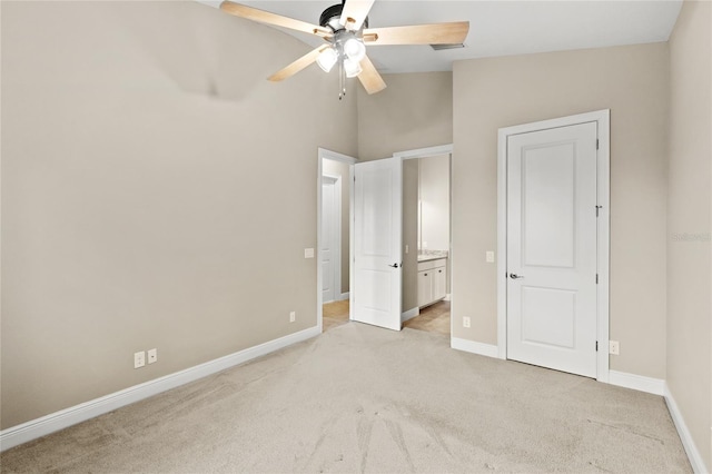 31754 Red Tail Blvd, Sorrento, FL 32776 - unfurnished bedroom with light carpet, baseboards, ensuite bathroom, a ceiling fan, and lofted ceiling