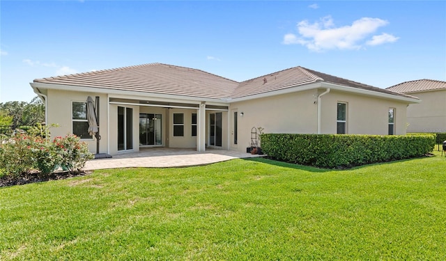 31754 Red Tail Blvd, Sorrento, FL 32776 - back of property featuring a tile roof, stucco siding, a lawn, and a patio