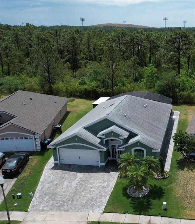 view from above of property with a heavily wooded area