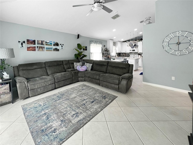 living room with a ceiling fan and light tile patterned floors