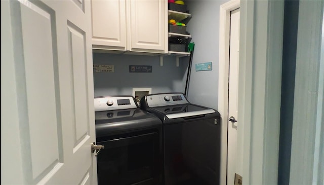 laundry area with washing machine and dryer and cabinet space