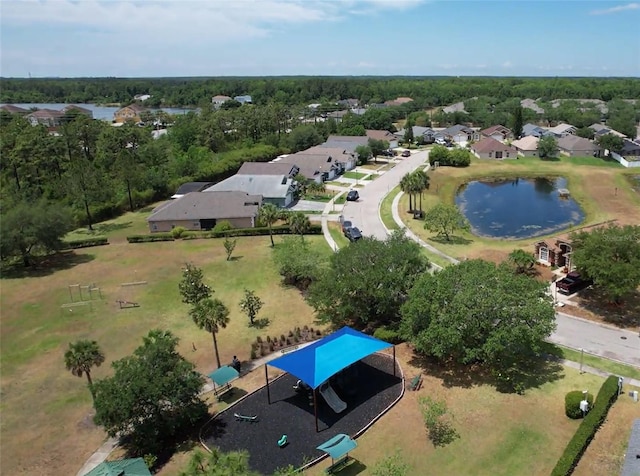 view of property location featuring a nearby body of water and nearby suburban area