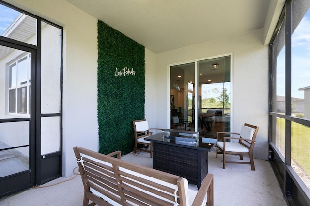 sunroom with healthy amount of natural light and outdoor lounge area