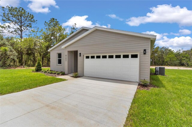 8202 SW 123rd Ter, Dunnellon, FL 34432 - view of front of property featuring cooling unit, driveway, a front yard, and an attached garage