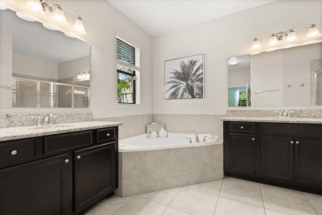 1501 Prairie Oaks Dr, Saint Cloud, FL 34771 - bathroom featuring a stall shower, tile patterned flooring, two vanities, and a garden tub