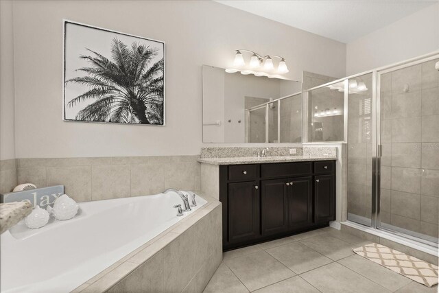 1501 Prairie Oaks Dr, Saint Cloud, FL 34771 - bathroom with vanity, a garden tub, a stall shower, and tile patterned floors
