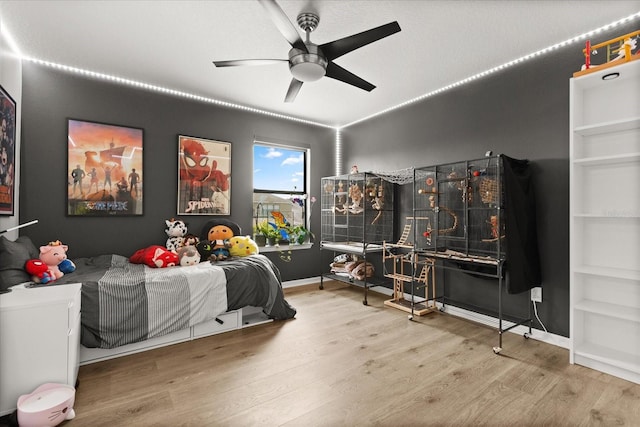 1501 Prairie Oaks Dr, Saint Cloud, FL 34771 - bedroom featuring wood finished floors, a ceiling fan, and baseboards