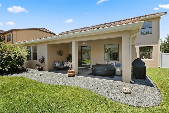 1501 Prairie Oaks Dr, Saint Cloud, FL 34771 - back of house with stucco siding, a patio area, a yard, and a tiled roof