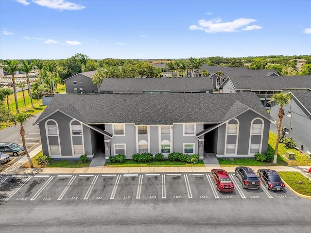 4160 Pershing Pointe Pl Unit 4, Orlando, FL 32822 - view of building exterior featuring uncovered parking