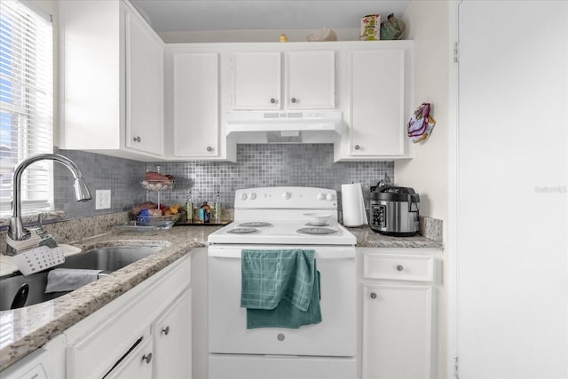 4160 Pershing Pointe Pl Unit 4, Orlando, FL 32822 - kitchen with under cabinet range hood, white range with electric stovetop, a sink, and white cabinetry