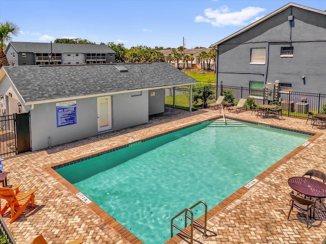 4160 Pershing Pointe Pl Unit 4, Orlando, FL 32822 - community pool with fence, a patio area, and a residential view
