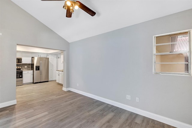5039 Jamaica Cir Unit 10, Orlando, FL 32808 - unfurnished living room with a ceiling fan, baseboards, light wood finished floors, and high vaulted ceiling